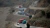 Trucks carry goods on its way to neighboring Afghanistan through the Khyber Pass in Pakistani tribal area, March 21, 2017. A Pakistani border official says hundreds of trucks have crossed into Afghanistan from Pakistan after the border reopened for the fi