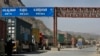 Trucks carrying NATO supplies wait in line at the Pakistan-Afghan border area of Torkham